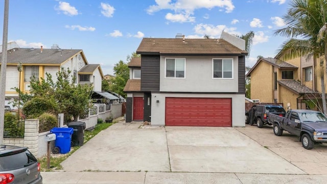 view of front of home with an attached garage, stucco siding, driveway, roof with shingles, and fence