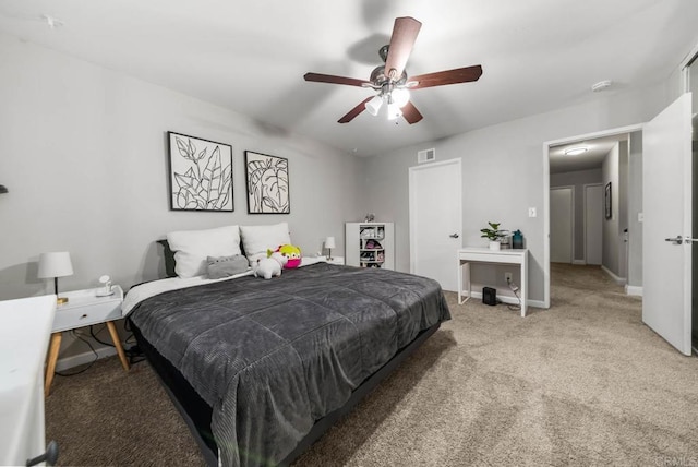 bedroom with light colored carpet, baseboards, and ceiling fan