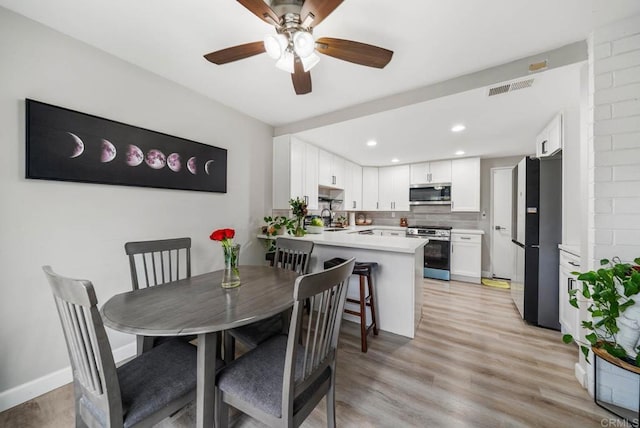 dining space with a ceiling fan, light wood-style flooring, and recessed lighting