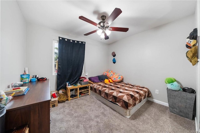 carpeted bedroom featuring ceiling fan and baseboards