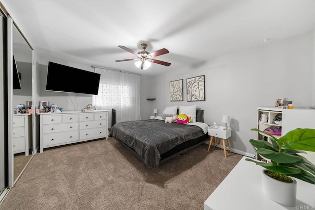 bedroom with carpet, a ceiling fan, and baseboards