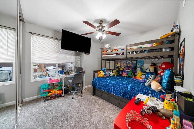 carpeted bedroom with a ceiling fan and baseboards