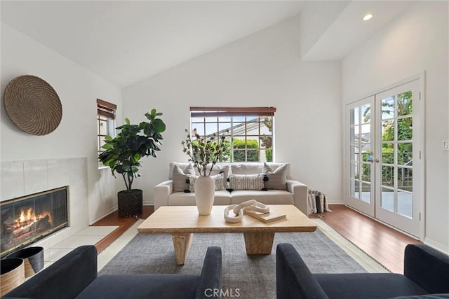 2405 Marshallfield Ln Unit B, Redondo Beach, CA 90278 - living room with high vaulted ceiling, wood finished floors, a tile fireplace, recessed lighting, and baseboards