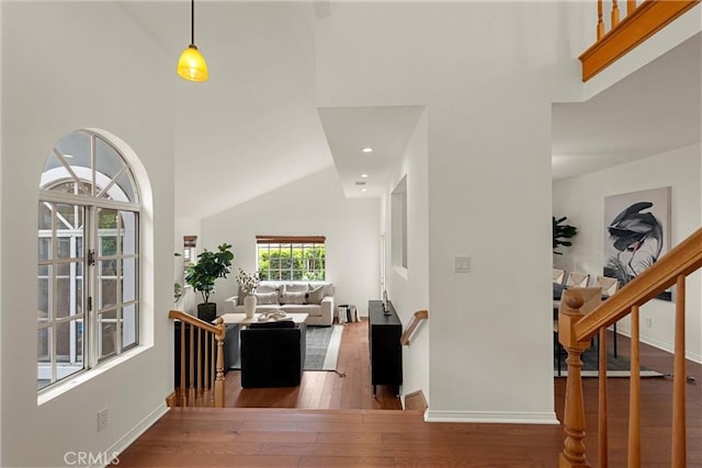 2405 Marshallfield Ln Unit B, Redondo Beach, CA 90278 - hall featuring high vaulted ceiling, hardwood / wood-style floors, baseboards, and stairway
