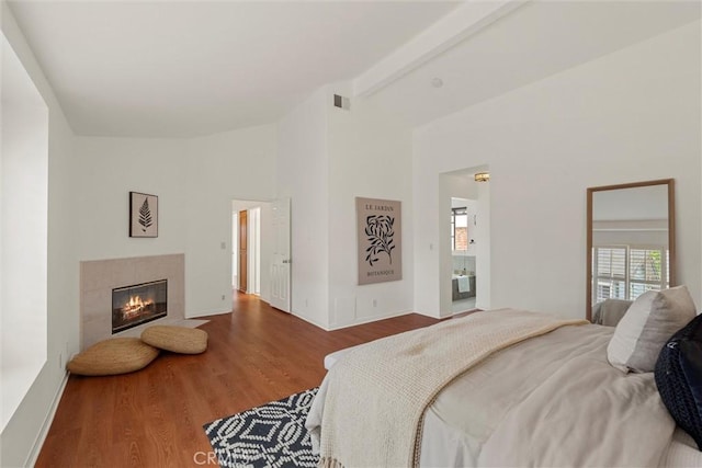 2405 Marshallfield Ln Unit B, Redondo Beach, CA 90278 - bedroom with wood finished floors, a fireplace, beam ceiling, and high vaulted ceiling
