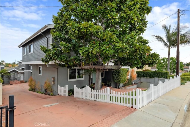 2405 Marshallfield Ln Unit B, Redondo Beach, CA 90278 - view of property hidden behind natural elements with stucco siding and a fenced front yard