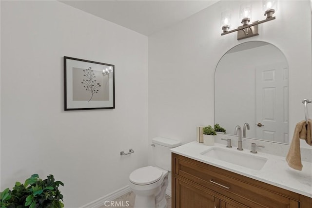 2405 Marshallfield Ln Unit B, Redondo Beach, CA 90278 - half bathroom with toilet, vanity, and baseboards