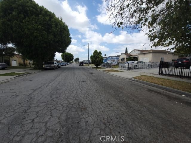 1307 S Grandee Ave, Compton, CA 90220 - view of asphalt road featuring sidewalks, a residential view, curbs, and street lights