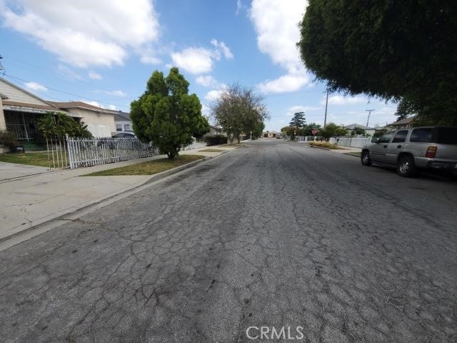 1307 S Grandee Ave, Compton, CA 90220 - view of asphalt street featuring sidewalks, curbs, and a residential view