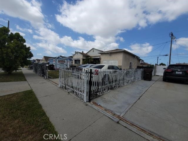 1307 S Grandee Ave, Compton, CA 90220 - view of side of home with a fenced front yard and a residential view