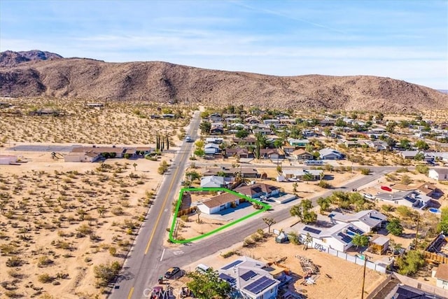 aerial perspective of suburban area featuring a mountainous background and property parcel outlined