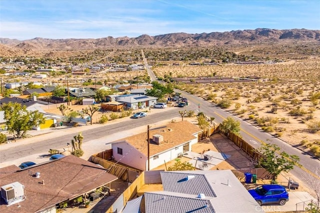 aerial view of residential area featuring a mountain backdrop and a desert landscape