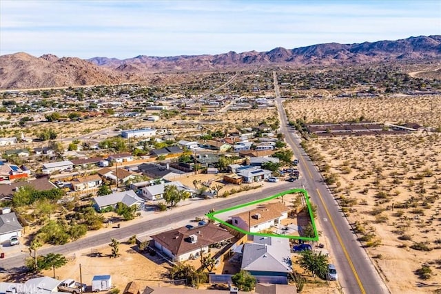aerial view of residential area featuring a mountain backdrop and property boundaries highlighted