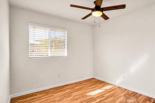unfurnished room featuring baseboards, light wood finished floors, and ceiling fan