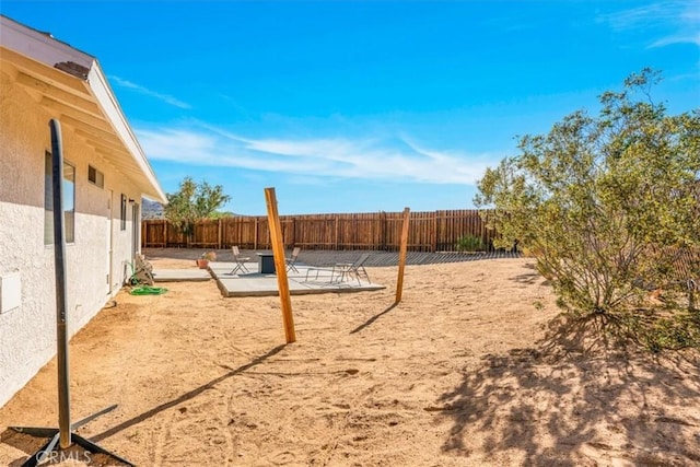 fenced backyard with a patio area