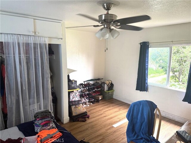106 N Encina Ave, Rialto, CA 92376 - bedroom featuring wood finished floors, a textured ceiling, ceiling fan, and baseboards