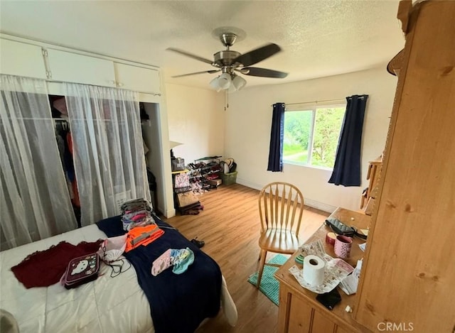 106 N Encina Ave, Rialto, CA 92376 - bedroom with wood finished floors, a ceiling fan, baseboards, and a textured ceiling