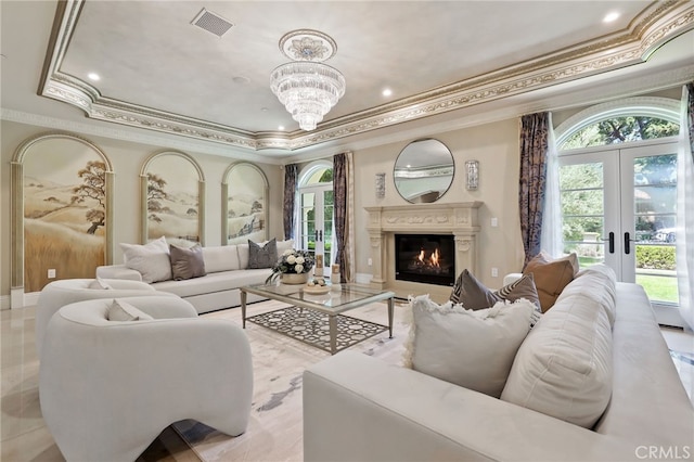 living area with ornamental molding, a tray ceiling, french doors, plenty of natural light, and recessed lighting