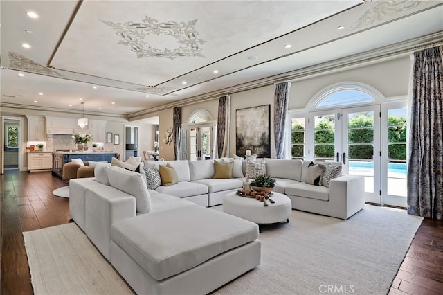 living room featuring french doors, healthy amount of natural light, ornamental molding, dark wood finished floors, and recessed lighting