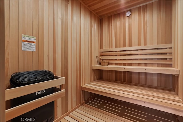 sauna / steam room with wood walls