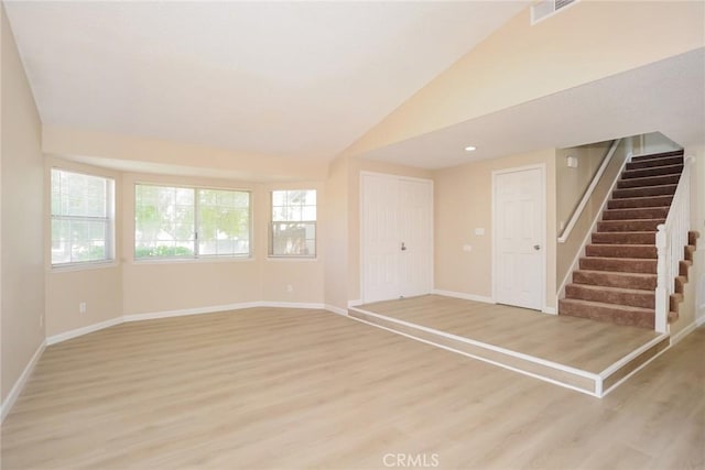 1536 Granicy Dr, Lancaster, CA 93535 - unfurnished room with stairs, baseboards, light wood finished floors, and lofted ceiling