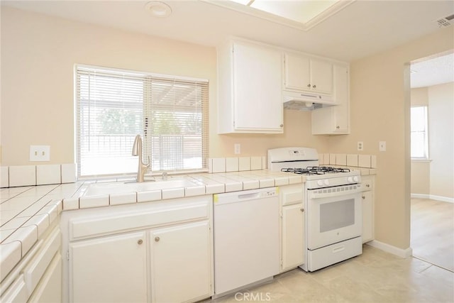 1536 Granicy Dr, Lancaster, CA 93535 - kitchen with white appliances, tile countertops, under cabinet range hood, a sink, and plenty of natural light