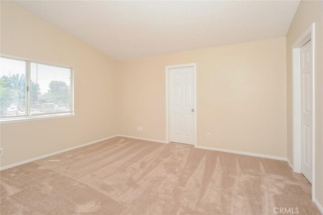 1536 Granicy Dr, Lancaster, CA 93535 - unfurnished bedroom featuring light carpet, baseboards, and lofted ceiling