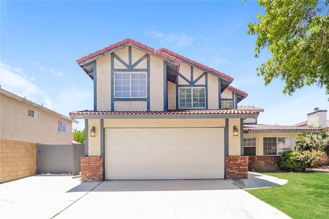 1536 Granicy Dr, Lancaster, CA 93535 - tudor-style house featuring brick siding, stucco siding, a tiled roof, concrete driveway, and fence
