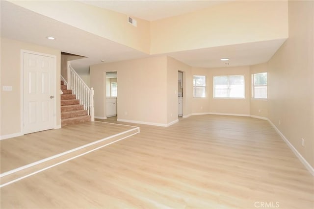 1536 Granicy Dr, Lancaster, CA 93535 - unfurnished room with baseboards, stairs, light wood-style floors, and recessed lighting
