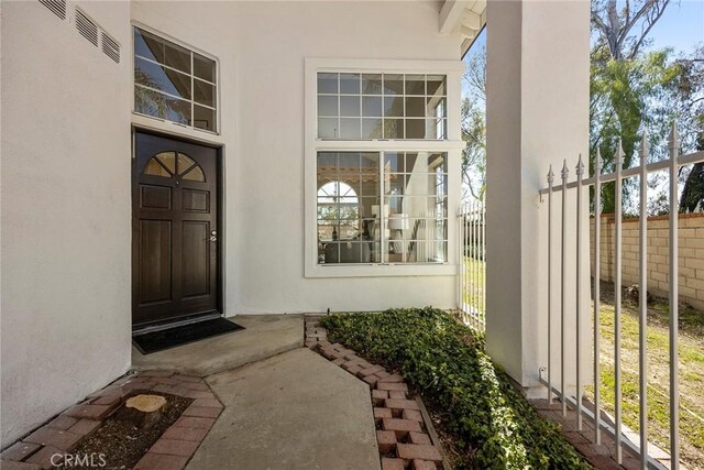 13639 Meadow Crest Dr, Chino Hills, CA 91709 - doorway to property featuring fence and stucco siding