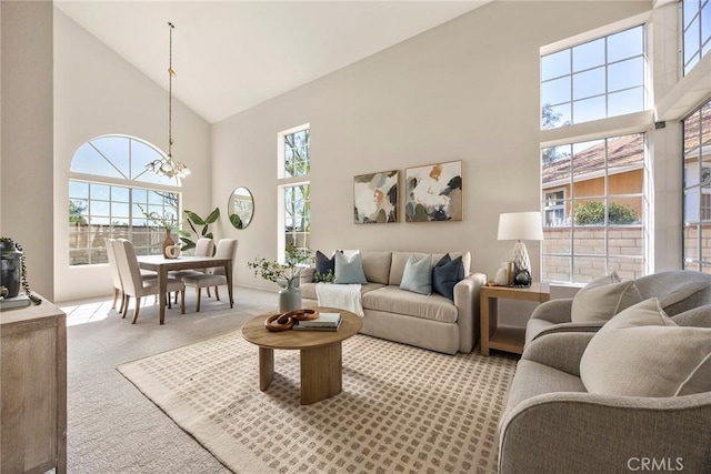 13639 Meadow Crest Dr, Chino Hills, CA 91709 - living area with high vaulted ceiling, carpet flooring, and a chandelier
