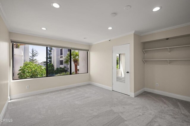 500 E Del Mar Blvd Unit 24, Pasadena, CA 91101 - unfurnished bedroom featuring carpet, ornamental molding, baseboards, recessed lighting, and a spacious closet