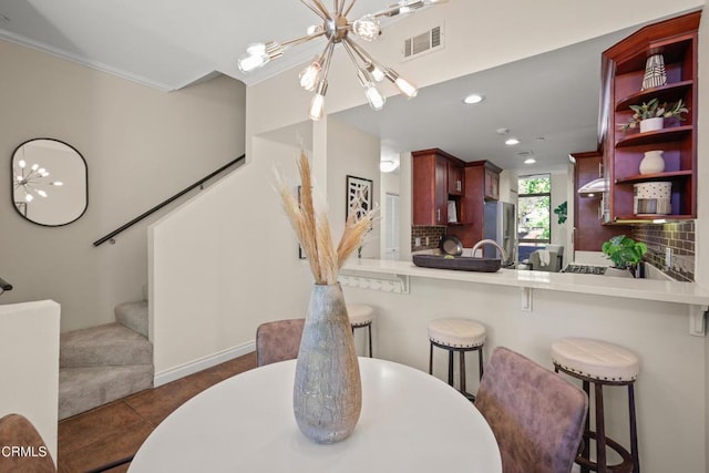 500 E Del Mar Blvd Unit 24, Pasadena, CA 91101 - dining space with a chandelier, stairway, recessed lighting, dark tile patterned floors, and ornamental molding