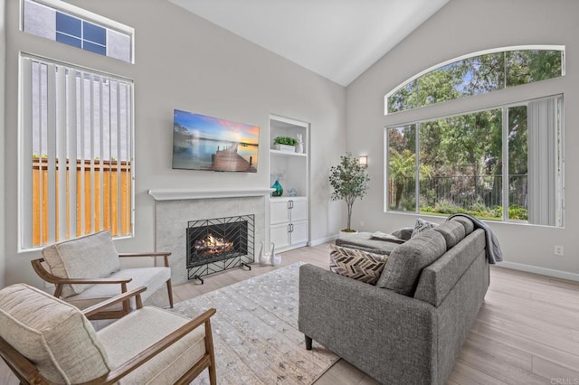 7794 Paseo La Jolla, Carlsbad, CA 92009 - living room with a premium fireplace, wood finished floors, baseboards, high vaulted ceiling, and built in shelves
