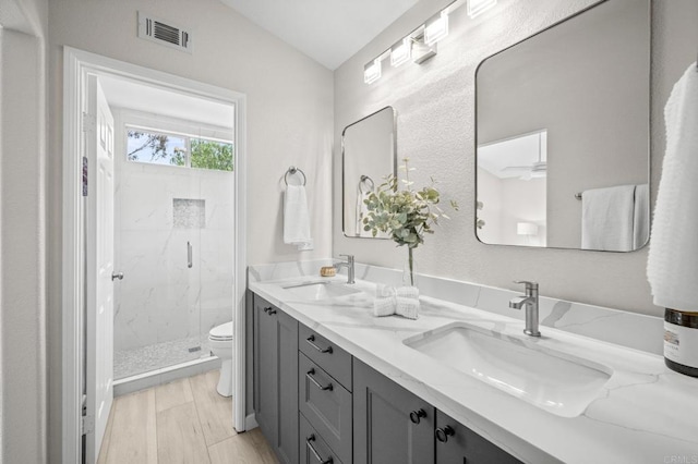 7794 Paseo La Jolla, Carlsbad, CA 92009 - bathroom with vaulted ceiling, a marble finish shower, toilet, wood finished floors, and double vanity