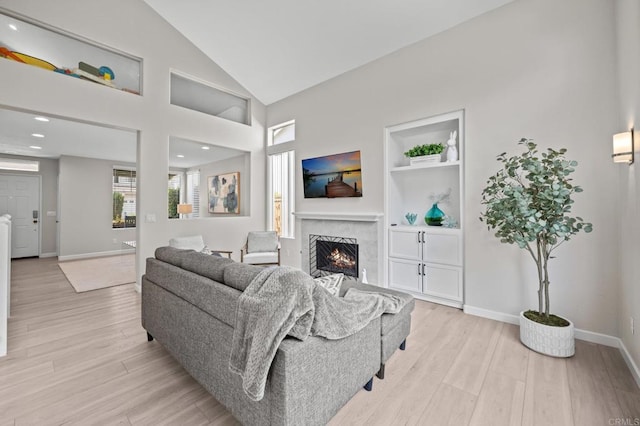 7794 Paseo La Jolla, Carlsbad, CA 92009 - living area featuring a fireplace, light wood finished floors, baseboards, lofted ceiling, and recessed lighting