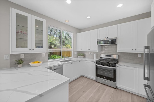 7794 Paseo La Jolla, Carlsbad, CA 92009 - kitchen featuring stainless steel appliances, light stone countertops, white cabinetry, glass insert cabinets, and recessed lighting