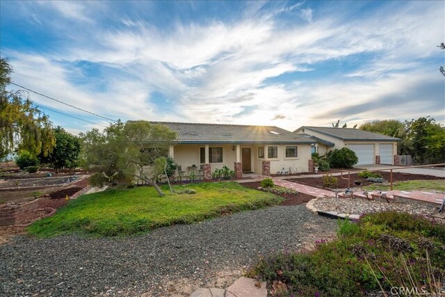 1561 Cielo Ln, Nipomo, CA 93444 - ranch-style house with covered porch, concrete driveway, an attached garage, a front lawn, and stucco siding