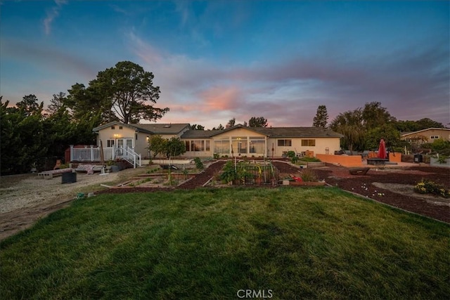 1561 Cielo Ln, Nipomo, CA 93444 - view of front of property featuring a vegetable garden, a lawn, a deck, and a patio area