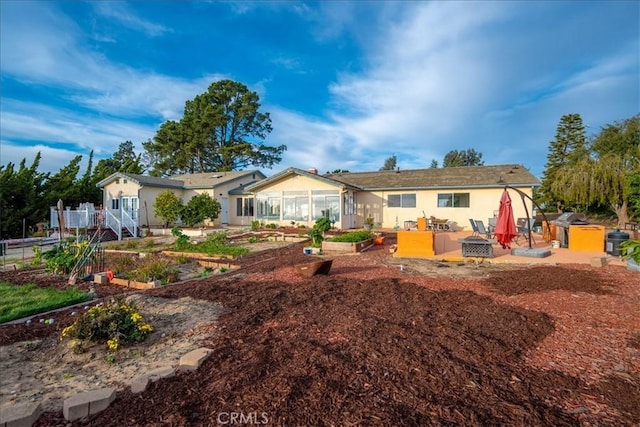 1561 Cielo Ln, Nipomo, CA 93444 - rear view of house with a vegetable garden, a patio, and stucco siding