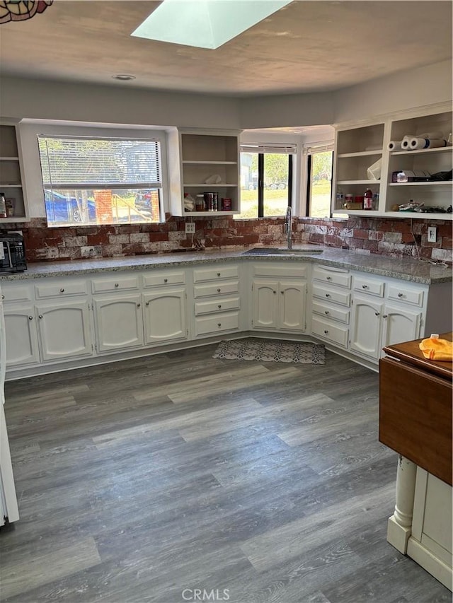 1561 Cielo Ln, Nipomo, CA 93444 - kitchen featuring open shelves, a sink, a skylight, white cabinets, and stone countertops
