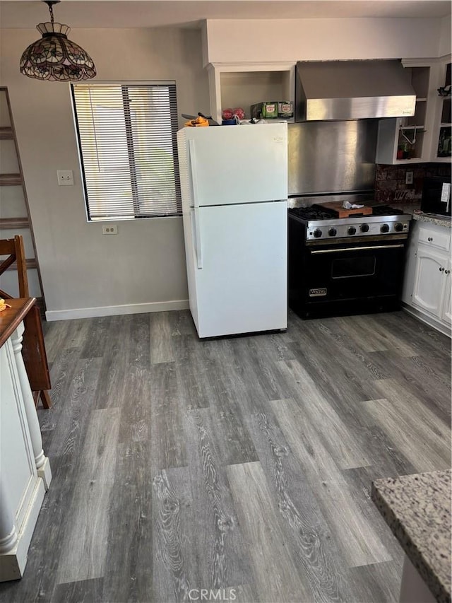 1561 Cielo Ln, Nipomo, CA 93444 - kitchen featuring freestanding refrigerator, designer stove, wall chimney range hood, dark wood-type flooring, and white cabinets