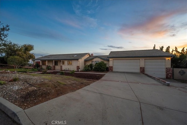 1561 Cielo Ln, Nipomo, CA 93444 - ranch-style home featuring driveway, a garage, brick siding, and stucco siding