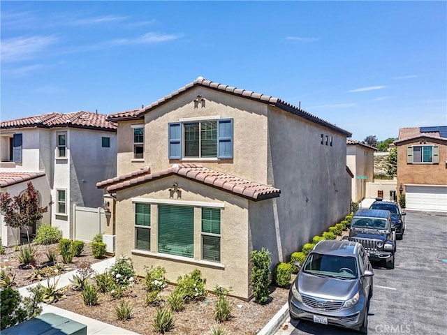 1952 Hazel Olson Ln, Colton, CA 92324 - mediterranean / spanish-style house with a tile roof, stucco siding, and fence