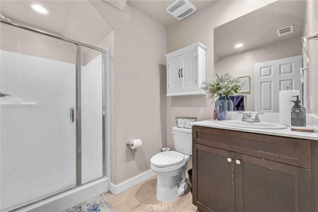 1952 Hazel Olson Ln, Colton, CA 92324 - bathroom featuring a stall shower, toilet, vanity, baseboards, and wood finished floors