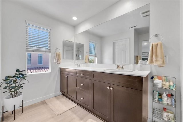 1952 Hazel Olson Ln, Colton, CA 92324 - bathroom featuring double vanity, wood finished floors, and baseboards