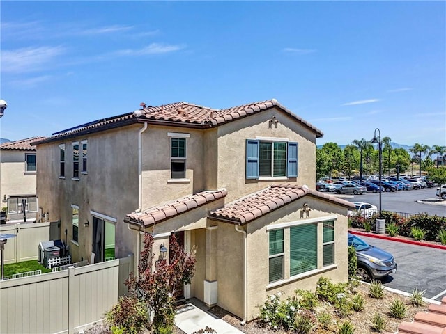 1952 Hazel Olson Ln, Colton, CA 92324 - mediterranean / spanish-style house with fence, a tiled roof, and stucco siding