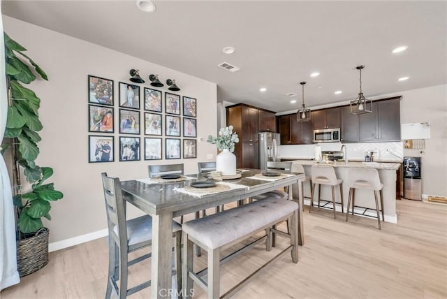 1952 Hazel Olson Ln, Colton, CA 92324 - dining room with light wood-style floors, baseboards, and recessed lighting