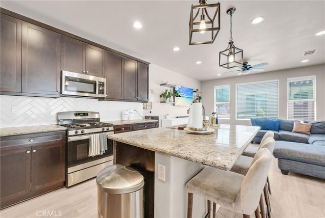 1952 Hazel Olson Ln, Colton, CA 92324 - kitchen featuring stainless steel appliances, open floor plan, ceiling fan, dark brown cabinets, and recessed lighting