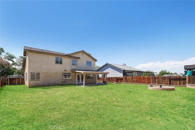 back of house with french doors, stucco siding, and a patio area